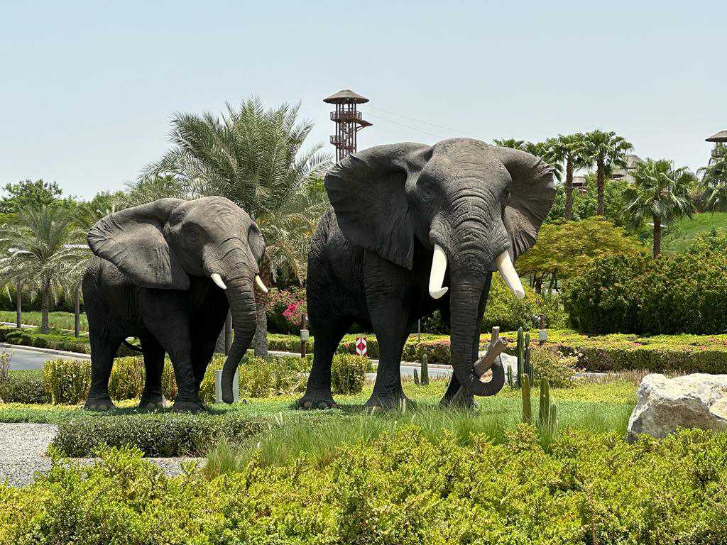 Installed elephant sculptures in a landscaped area at Dubai Safari Park